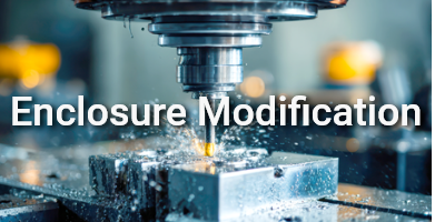 Close-up of a CNC milling machine machining a metal block with chips and coolant. On-image text: ‘Enclosure Modification’ – representing custom machining of electronic enclosures. Close-up of a CNC milling machine machining a metal block with chips and coolant. On-image text: ‘Enclosure Modification’ – representing custom machining of electronic enclosures.