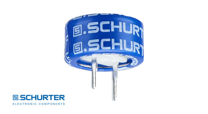 Blue SCHURTER SCCA series supercapacitor with radial leads, isolated on a white background.